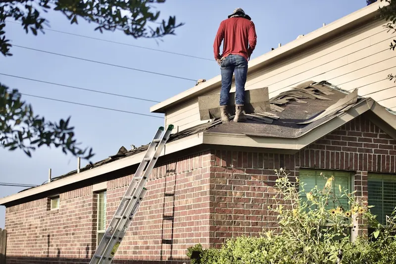 Professional roofer working on a residential roof in Newtown Square